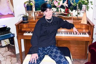 Here is an image of Yesim sitting in front of a piano looking cool.